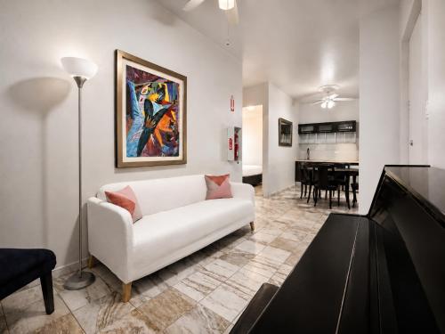 a living room with a white couch and a table at Coral Princess Hotel in San Juan