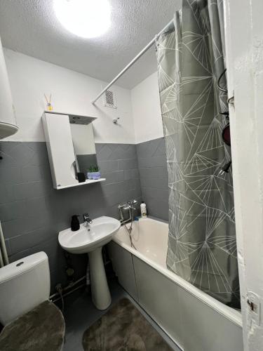 a bathroom with a sink and a tub and a toilet at Mykolaichuka in Chernivtsi