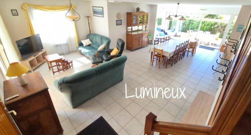 a living room with a couch and chairs and a table at Maison 5 chambres, 3 SdB, proche plage in Arzon