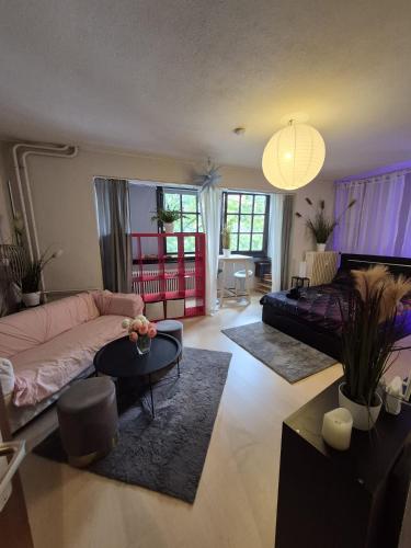 a living room with a couch and a table at Modern & Quiet City Apartment in Hannover
