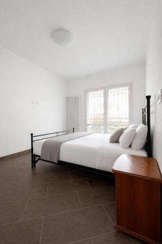 a bedroom with a large bed with white sheets and pillows at Ground floor house in Castel Bolognese