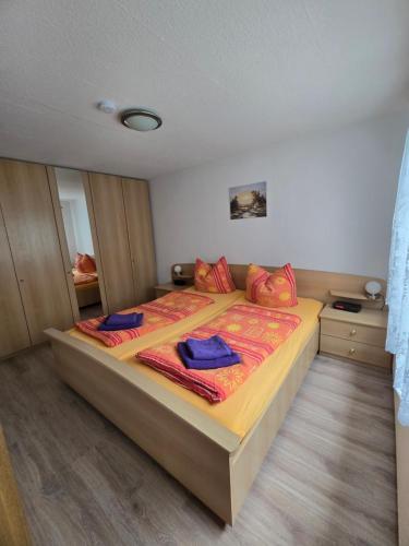 a bedroom with a large bed with red pillows at Ferienhaus Parnet in Neudorf