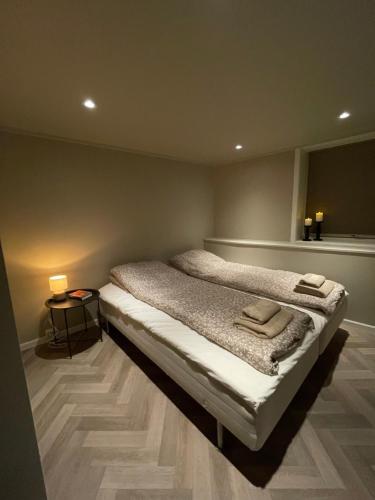 a bedroom with a bed with two towels on it at Halden downtown apartment in Halden