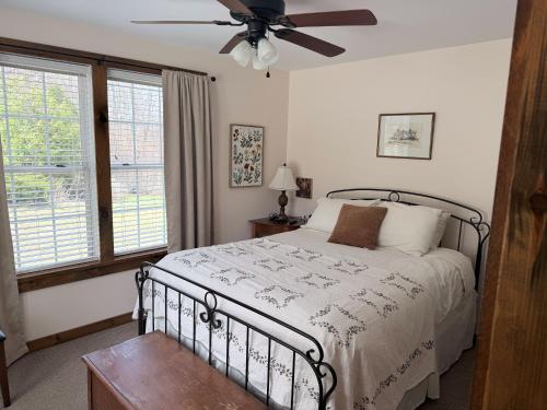 a bedroom with a bed and a ceiling fan at The Old Lantern Inn in Charlotte