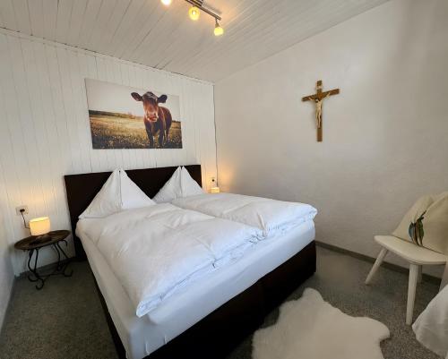 a bedroom with a bed with a cross on the wall at Wolfbachgut - Ferienwohnung 5 in Taxenbach
