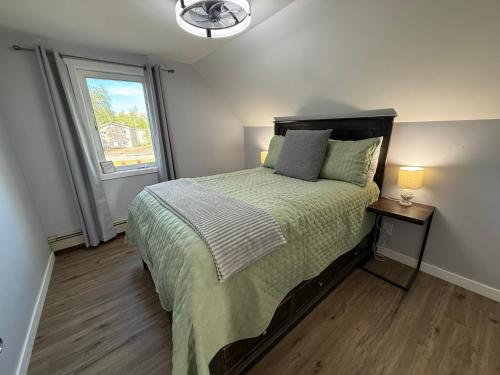 a bedroom with a large bed and a window at The Downtown Loft in Fairbanks