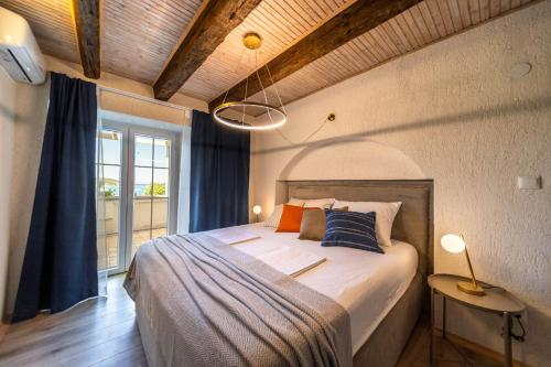 a bedroom with a bed and a large window at Beach Suite Nina in Rab