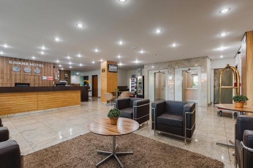 a waiting room with chairs and a table in a hospital at Savana Hotel in Uberlândia