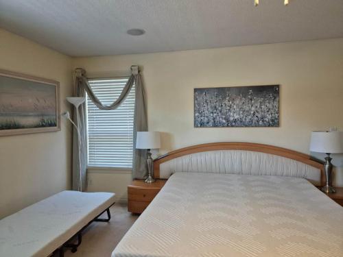 a bedroom with a large bed and a window at Meadowridge Haven in Maple Ridge