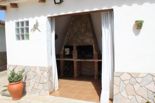 an open door into a house with a stone wall at Casa Rural Paraje La Venta in Pliego