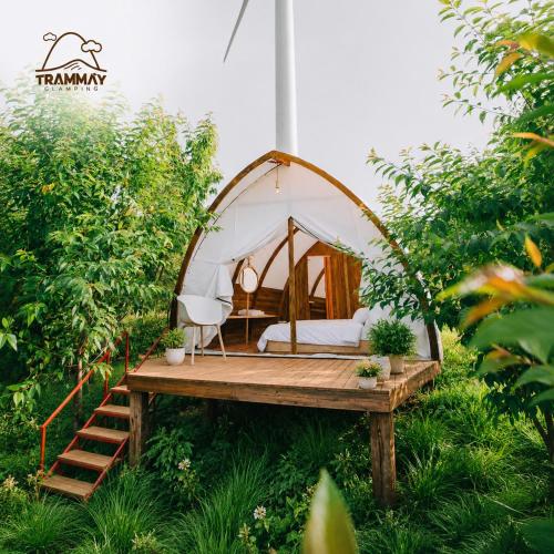a bed in a gazebo in a garden at Trạm Mây Glamping in Da Lat