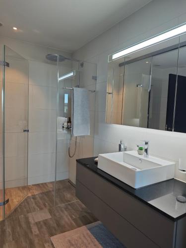 a bathroom with a white sink and a shower at Sun Tower in Zurich