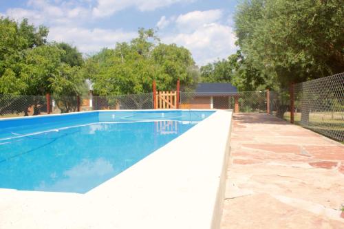 a swimming pool in a yard with a fence at Lo de Chimila in San Javier