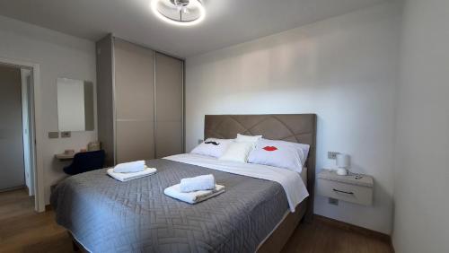 a bedroom with a large bed with towels on it at Villa Stanić in Omiš