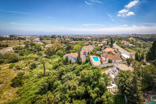 an aerial view of a city with trees and houses at Dar Almaz in Mijas