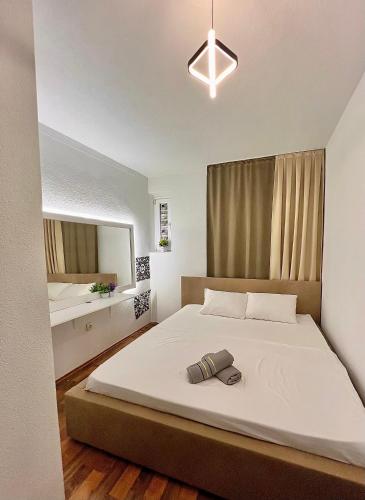 a bedroom with a large white bed and a mirror at PARIS Luxury Center Apartment STRUGA in Struga