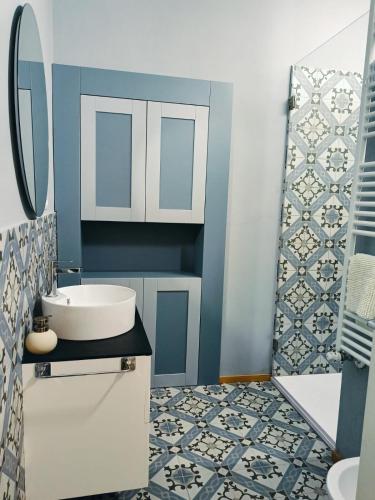 a bathroom with a white sink and a mirror at A casa di Anna in Cocconato