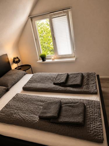 a bedroom with two beds and a window at STAY - City W32 in Friedrichshafen