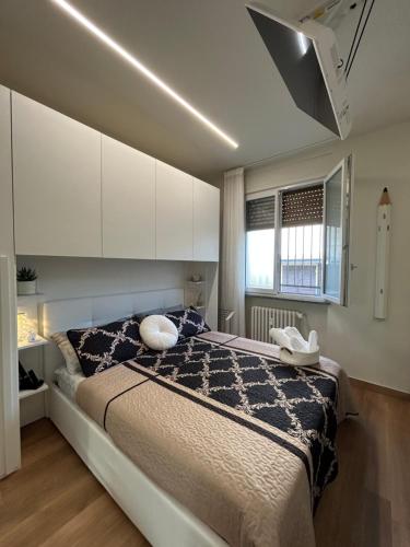 a bedroom with a large bed with white cabinets at Corona dei Sogni Appartamento moderno vicino Ospedale e Centro in Novara