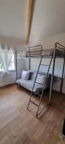 a room with two bunk beds and a wooden floor at La Grange in Champagne-de-Blanzac