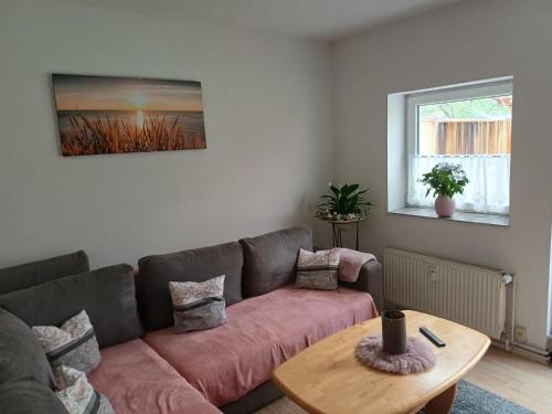 a living room with a couch and a table at Ferienwohnung Wusterwitz in Wusterwitz