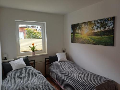 two beds sitting in a room with a window at Ferienwohnung Wusterwitz in Wusterwitz