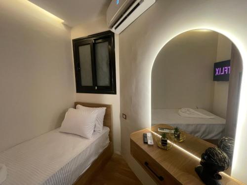 a small room with two beds and a mirror at Latina City in Cairo
