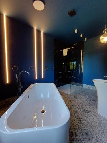 a large bathroom with a tub and a shower at Hotel Dom Marynarza in Gdynia