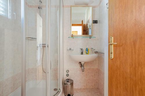 a bathroom with a shower and a sink at Villa Bunta in Sutivan