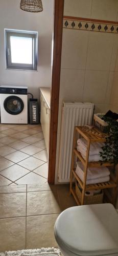 a small kitchen with a stove and a microwave at Vrisi House in Kiparission