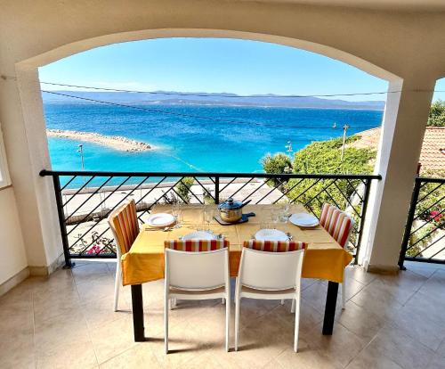 a dining room with a view of the ocean at Apartments Matea in Bol