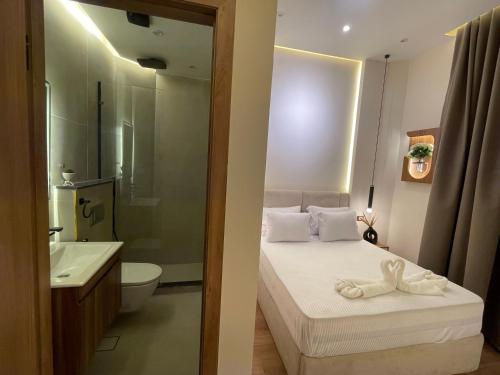 a bathroom with a bed and a toilet and a sink at Latina City in Cairo