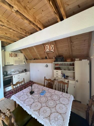 a kitchen with a table with chairs and a refrigerator at Peaceful Cottage in Bijelo Polje