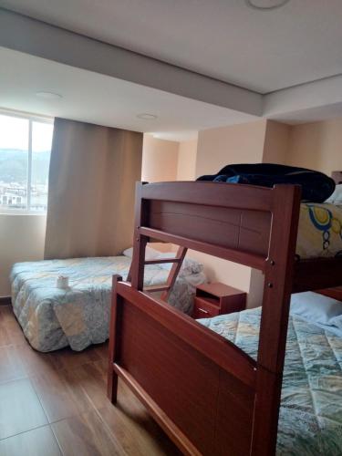 a bedroom with two bunk beds and a window at HOSPEDAJE YACUCALLE in Ibarra