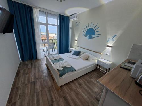 a bedroom with a bed and a large window at LA PLAYA - Studiouri pe plaja cu sezlong inclus in Eforie Nord