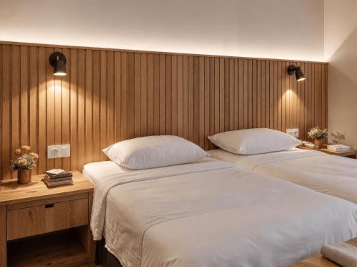 two beds in a room with wooden walls at Bella Rose Apart Hotel, Alanya in Alanya