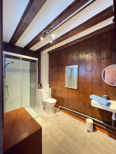 a bathroom with a toilet and a glass shower at La Canetterie in Dole