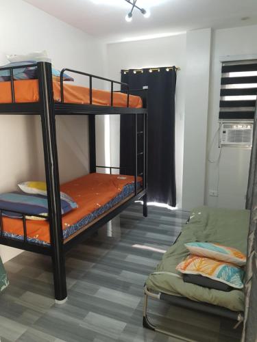 a bedroom with two bunk beds in a room at The WhiteHouse Inn in Calumpit