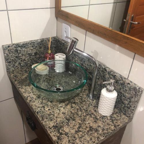 a bathroom sink with a green hose on it at Pousada Village dos Canyons in Praia Grande