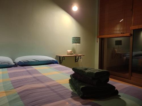 a bedroom with a bed and a table with a lamp at Cal Pedrellar in Colldejou