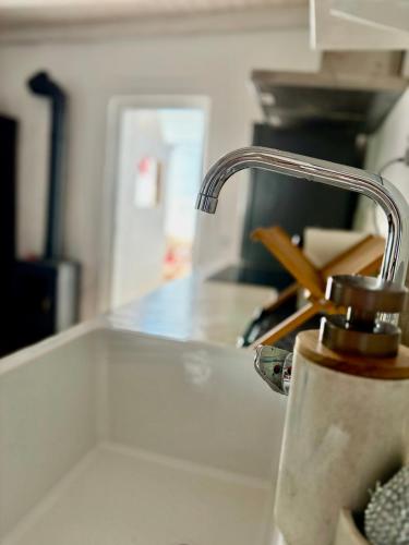a kitchen counter with a faucet on a sink at Casa Alma Clara in Odemira