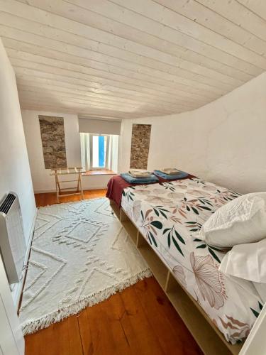 a bedroom with a bed in a room at Casa Alma Clara in Odemira