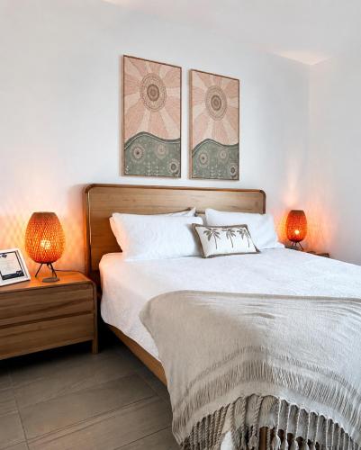 a bedroom with a large bed with two lamps at Cairns Waterfront Luxury at Harbourlights in Cairns