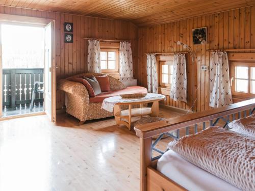 a living room with a couch and a table at Im Bayerischen Wald in Viechtach