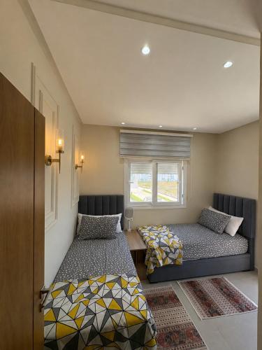 a bedroom with two beds and a window at New Luxury apartment with 3 pool in Cabo Negro