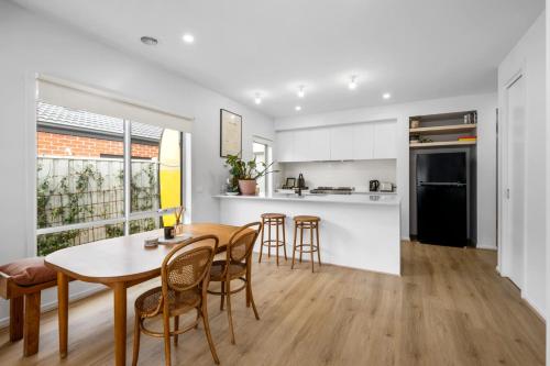 a kitchen and dining room with a table and chairs at 3BR Light-filled Retreat Mt Duneed in Mount Duneed