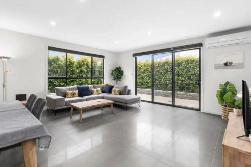 a living room with a couch and a table at Seaside Retreat, St Leonards in Saint Leonards