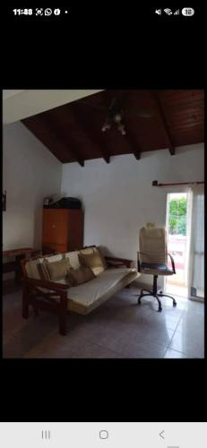 a bedroom with a bed and a chair in it at Rendel in Paraná