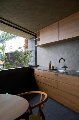 a kitchen with wooden cabinets and a sink and a window at Seaside Villa SEEN Shallow Sea in Onomichi