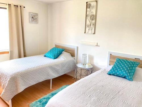 a bedroom with two beds with blue pillows at Near Yellowstone Park and Chico Hot Springs in Emigrant